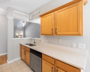 A remodeled kitchen in the city with a sink, dishwasher, and cabinets.