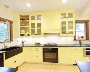 A Venice kitchen remodel featuring yellow cabinets and black counter tops.