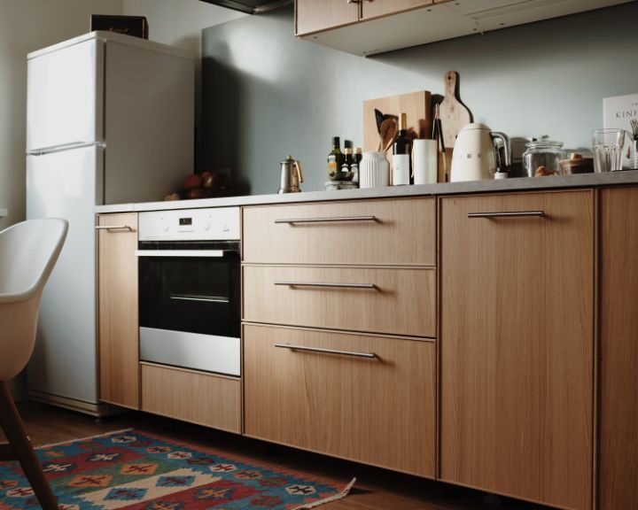 A city kitchen with a stove, refrigerator, and dining table.