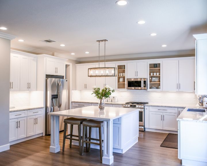 A refurbished kitchen in the city featuring a center island and white cabinets.